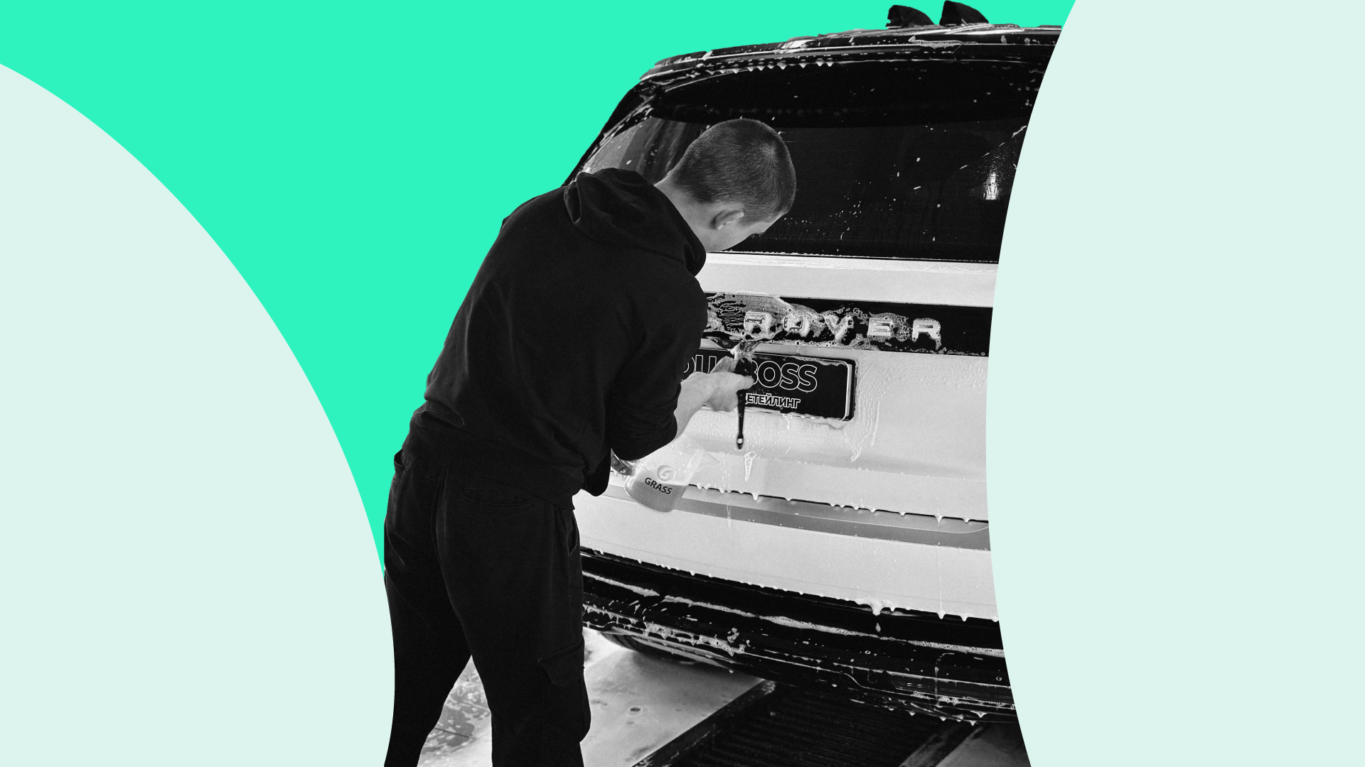 Man using equipment to clean a car numberplate